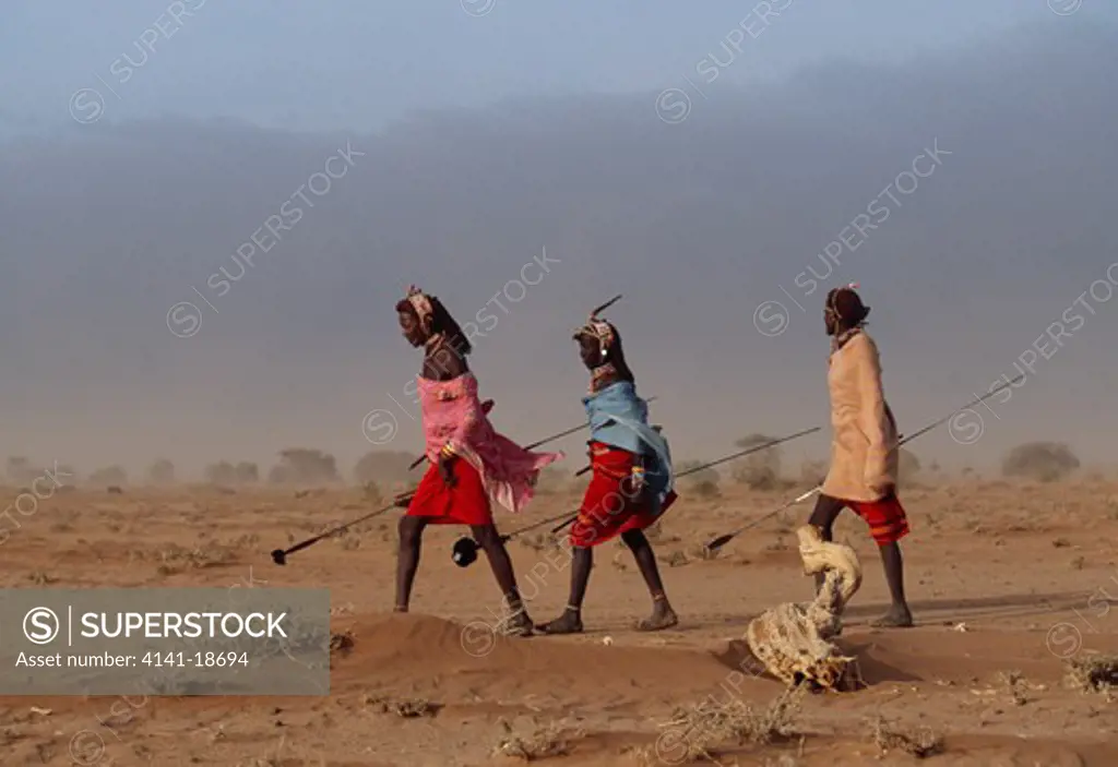 rendille warriors walking during sandstorm kenya, east africa