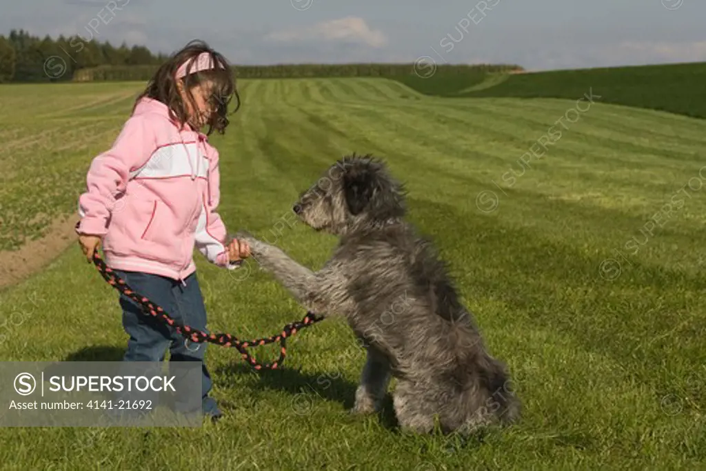 young girl playing with dog