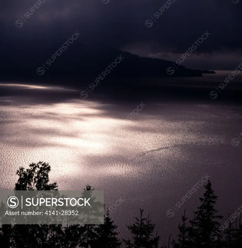 light shimmering on water tyrifjorden, buskerud, norway.