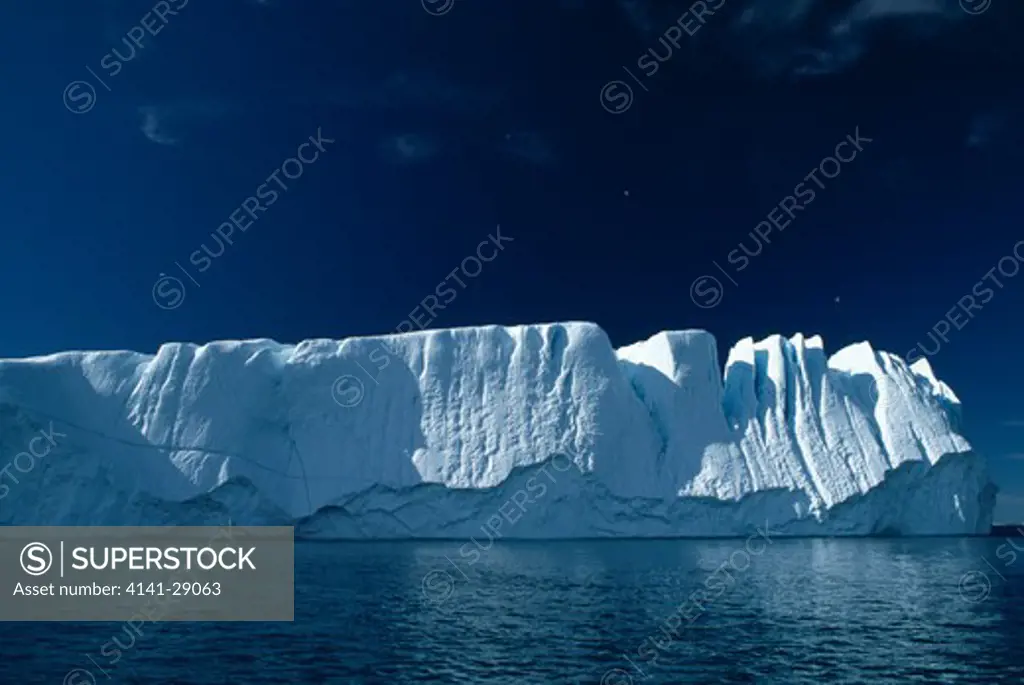 tabular iceberg towering iceberg eroded by wind & water greenland 