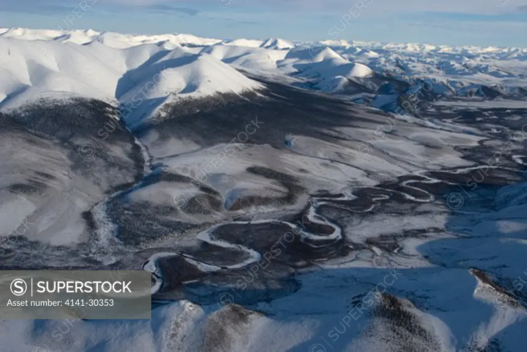 aerial of snow covered northern ogilvie mountains and whitestone river in yukon territory. edge of boreal forest and treeline. canada. 