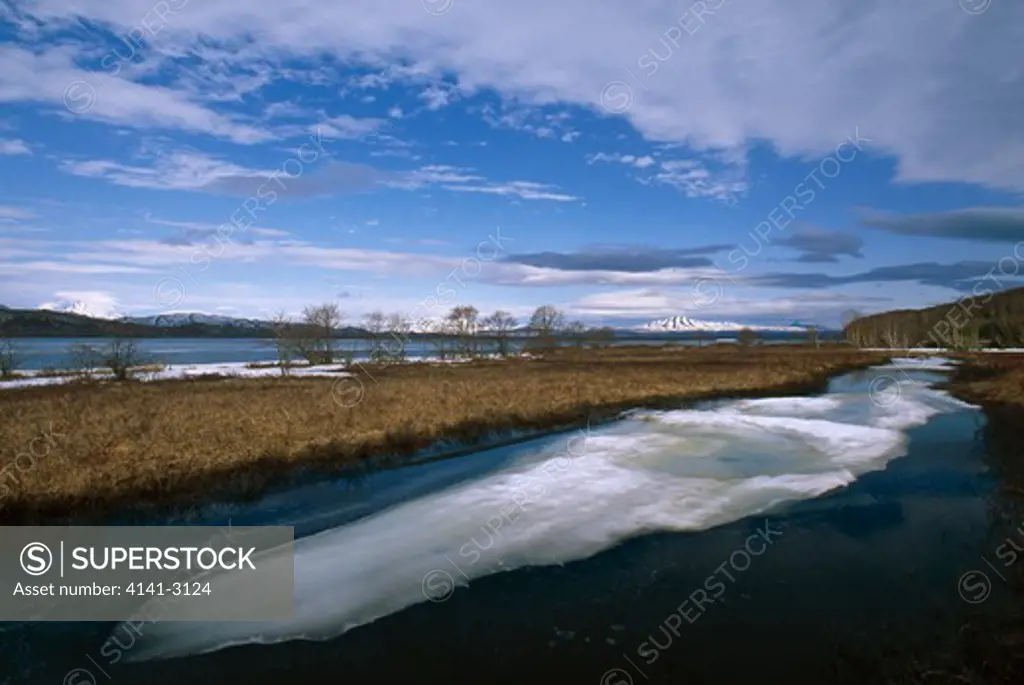 zuphanova river on tundra with ice kamchatka peninsula, siberia, russia