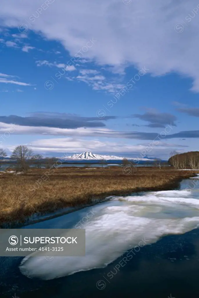zuphanova river with ice june tundra pools & mountains kamchatka peninsula, siberia, russia 