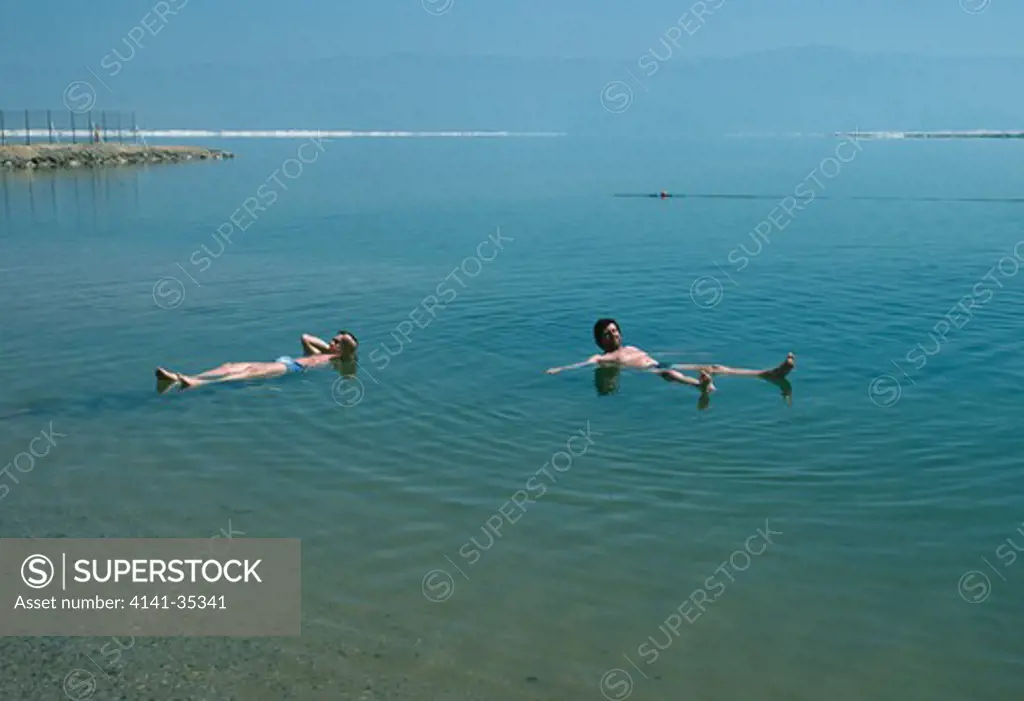 dead sea (southern end) israel with people floating note salt accumulation in distance