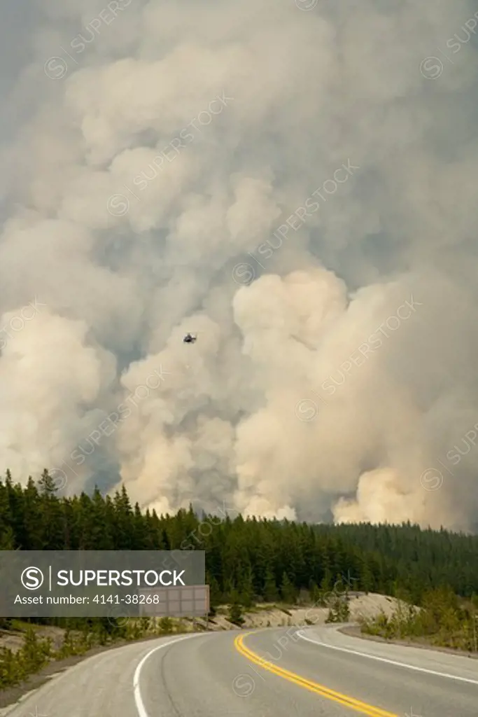 forest fire - controlled burn june 2009 with fire setting helicopter, saskatchewan valley, banff national park, alberta, canada 