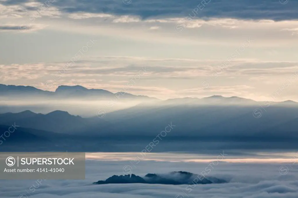 dawn over mist shrouded ljubljana basin looking towards kamnik alps, tehovec, slovenia date: 06.11.2008 ref: zb812_123820_0017 compulsory credit: nhpa/photoshot