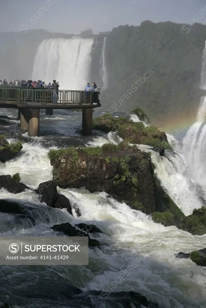 iguazu falls with tourists, iguacu national park, brazil.