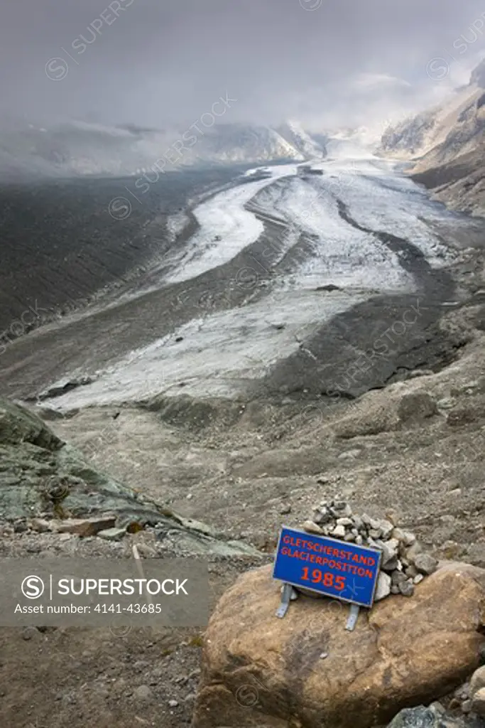 retreat of glacier pasterze of mount grossglockner with a sign showing the glacier position 1985 europe, central europe, austria, october 2009