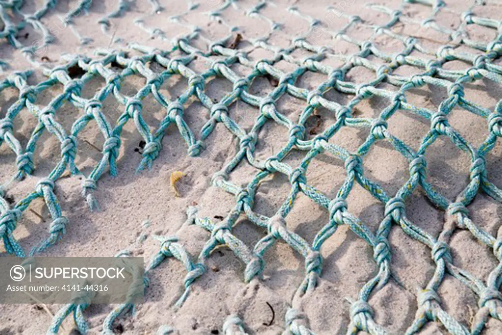 discarded piece of trawl net washed up onto shore and lying in sand bryher, isles of scilly, uk date: 15.10.2008 ref: zb869_126375_0001 compulsory credit: woodfall wild images/photoshot 