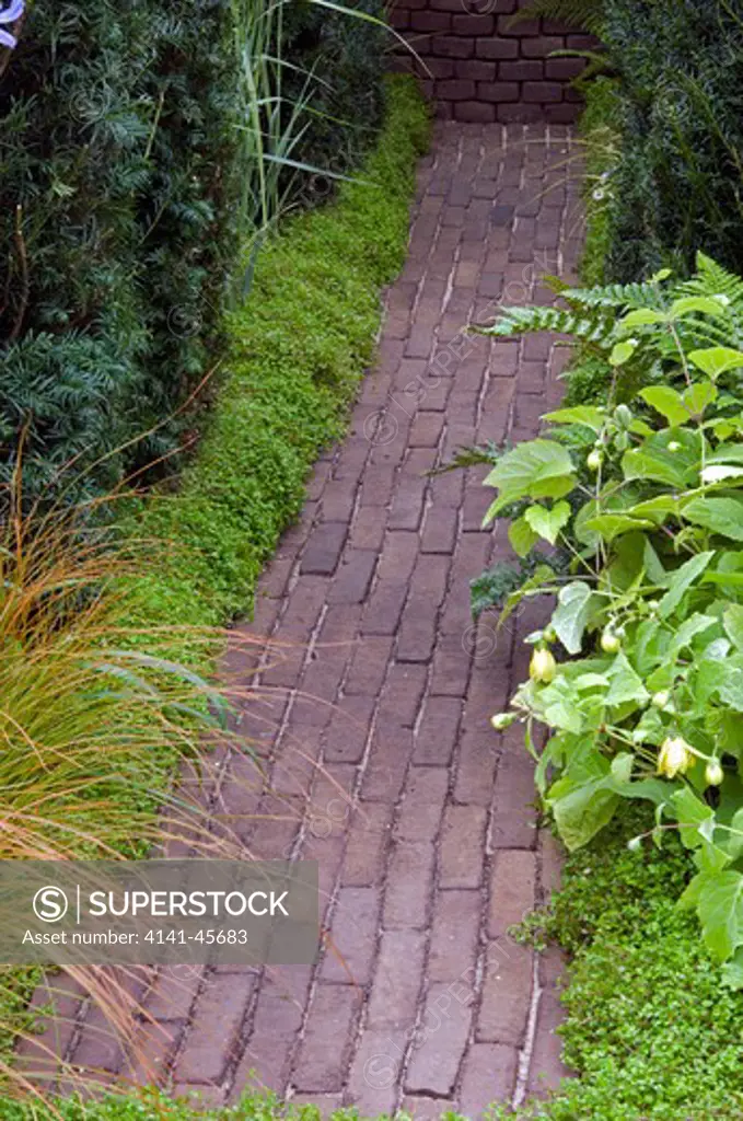 path of bricks, edges softened with plants. date: 06.11.2008 ref: zb907_123798_0011 compulsory credit: photos horticultural/photoshot 