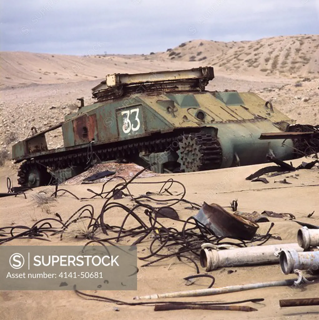 the rusted remains of a second world war sherman tank that was used for a period after the war to clear namib desert dune 'overburden' (to reveal diamond bearing bedrock that lies beneath), at the namdeb diamond mine, southern namibia.