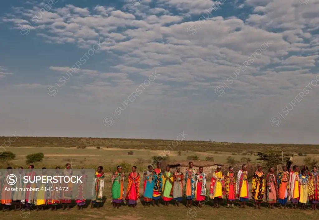 masai women dancing and singing a welcome song, kenya.