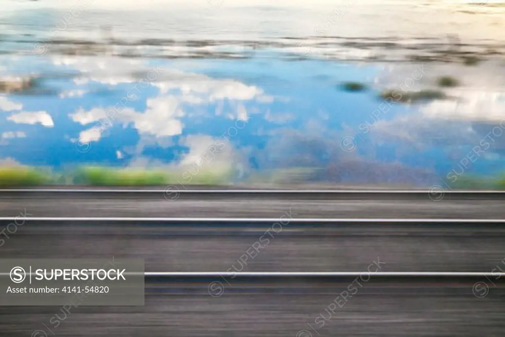 Motion Of Rails And The Passing Landscape, Including Reflections Off A Lake Near The Tracks, Viewed From The Amtrak Empire Builder In Montana, Usa, Empire_Builder-271