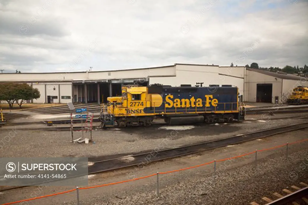 Bnsf Locomotive Painted In The Old Atchison, Topeka, And Santa Fe Railway Colors Parked In A Railroad Yard In Seattle In Washington State, Viewed From The Amtrak Empire Builder, Usa, Empire_Builder-471