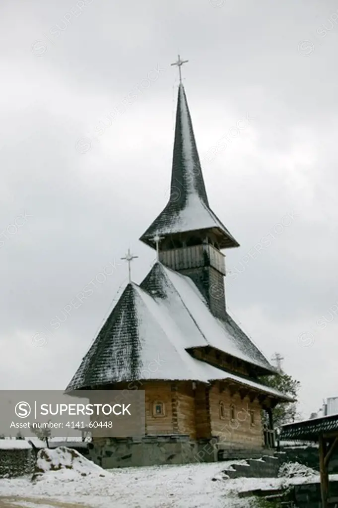 Traditional Wooden Church Covered In Snow, Romania