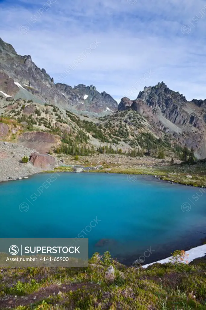 Imperial Tarn with its colorful aqua tint due to glacial flour, in the cirque of Royal Basin in Olympic National Park, Washington State, USA.