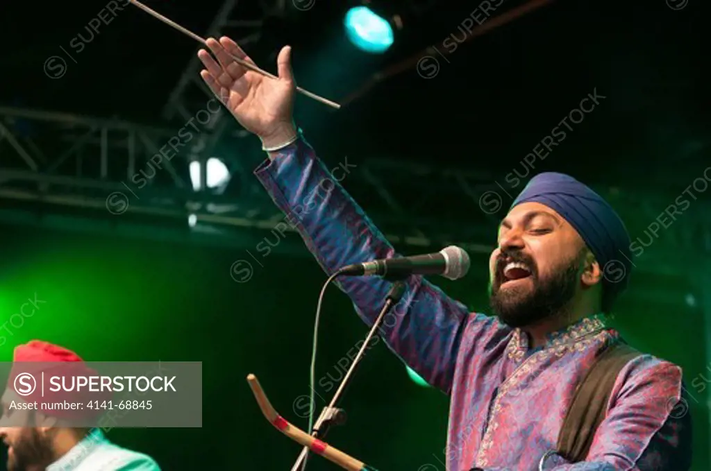 Buzz Singh of the English bhangra band Kissmet on stage during the Salisbury Arts Festival