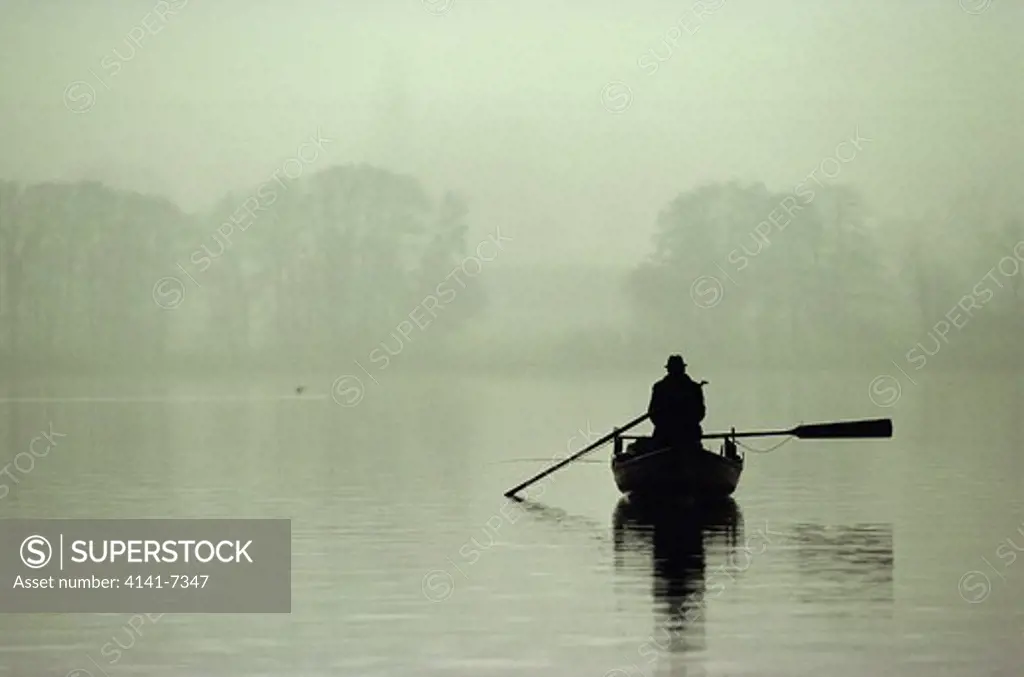 angler in boat on lake canton of zurich switzerland