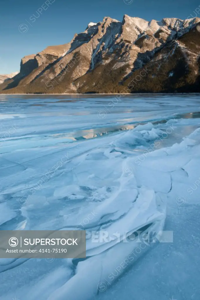 Mount Inglismaldie and ice formations on Lake Minnewanka; Banff National Park, Alberta, Canada.