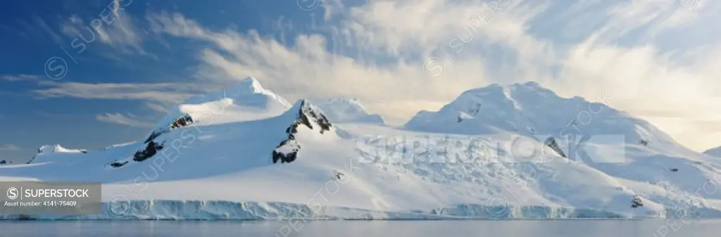 Mountains, glaciers, clouds; Half Moon Bay, Antarctic Peninsula, Antarctica.