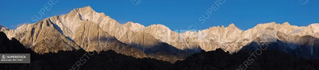 The Sierra Nevada mountains with Lone Pine Peak on the left and Mt Whitney just right of center.  Mt Whitney is the highest summit in the contiguous United States with an elevation of 14505 feet.  This photo is taken in early morning, from the Alabama Hills near Lone Pine, California.