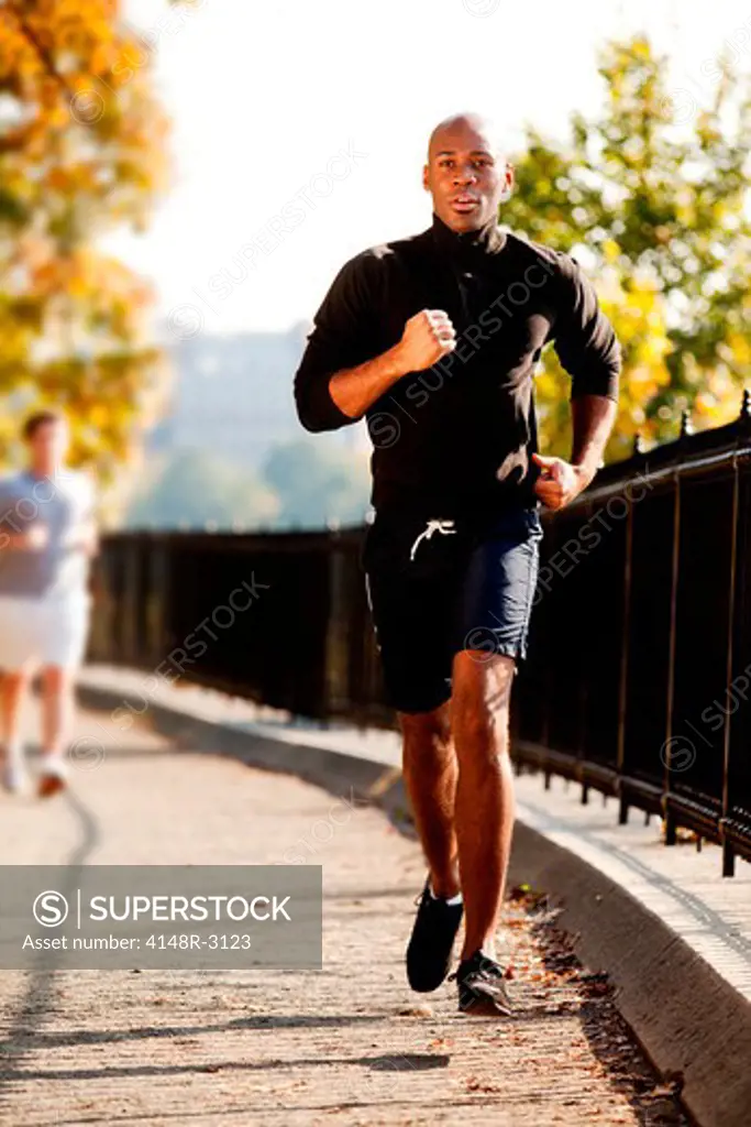 An African American jogging in a park in the morning