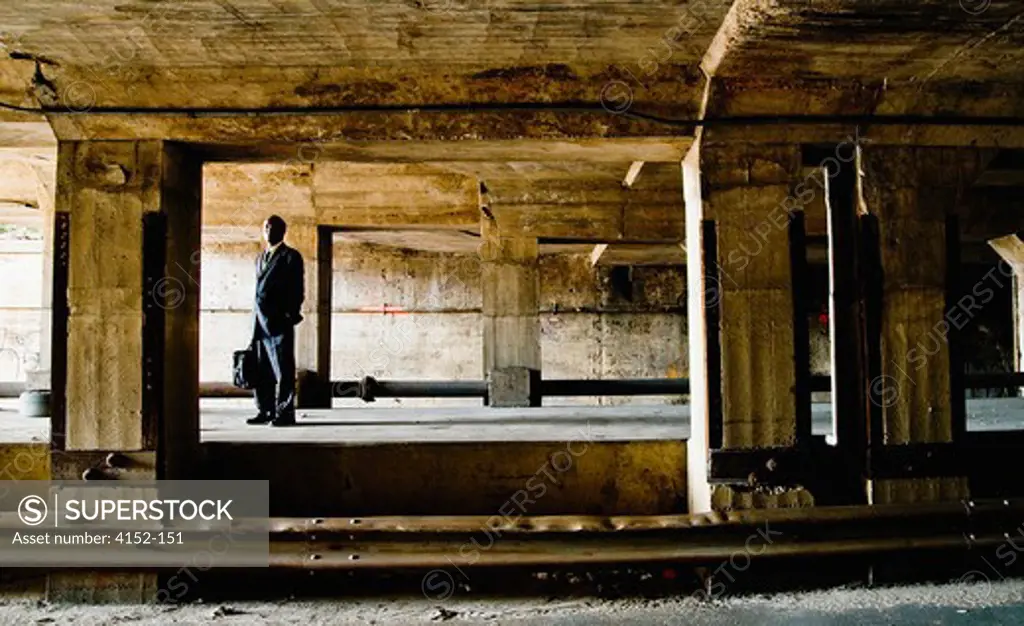Businessman standing in an abandoned building