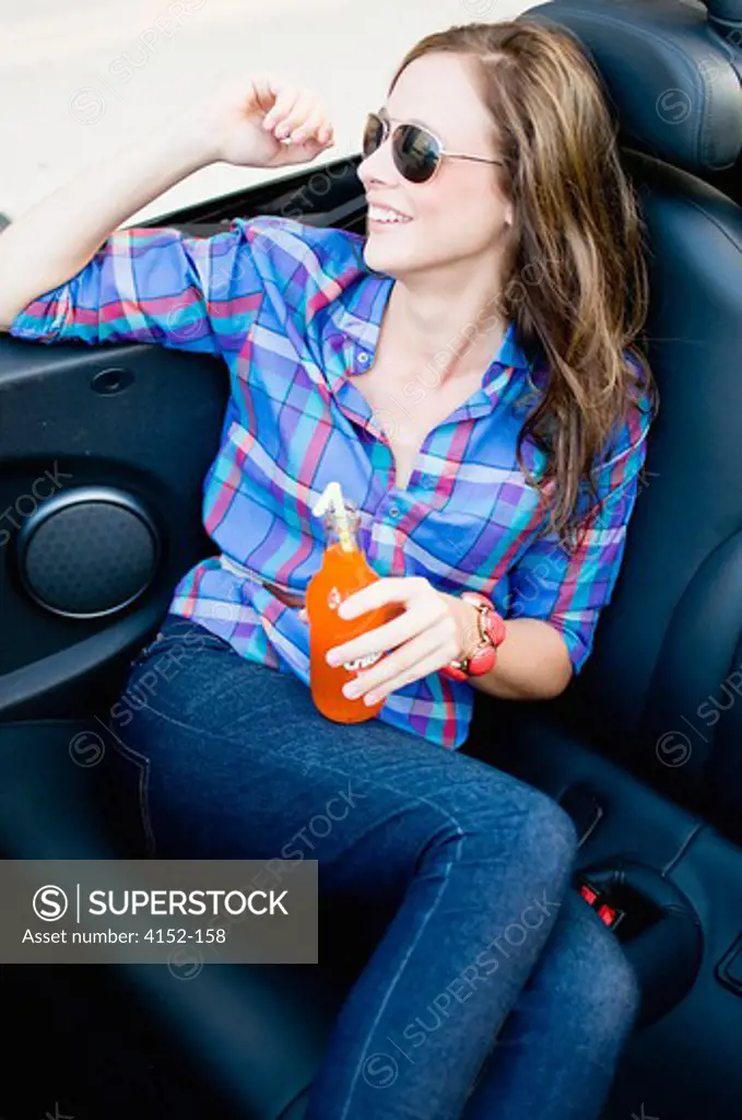 Woman sitting in a car and smiling