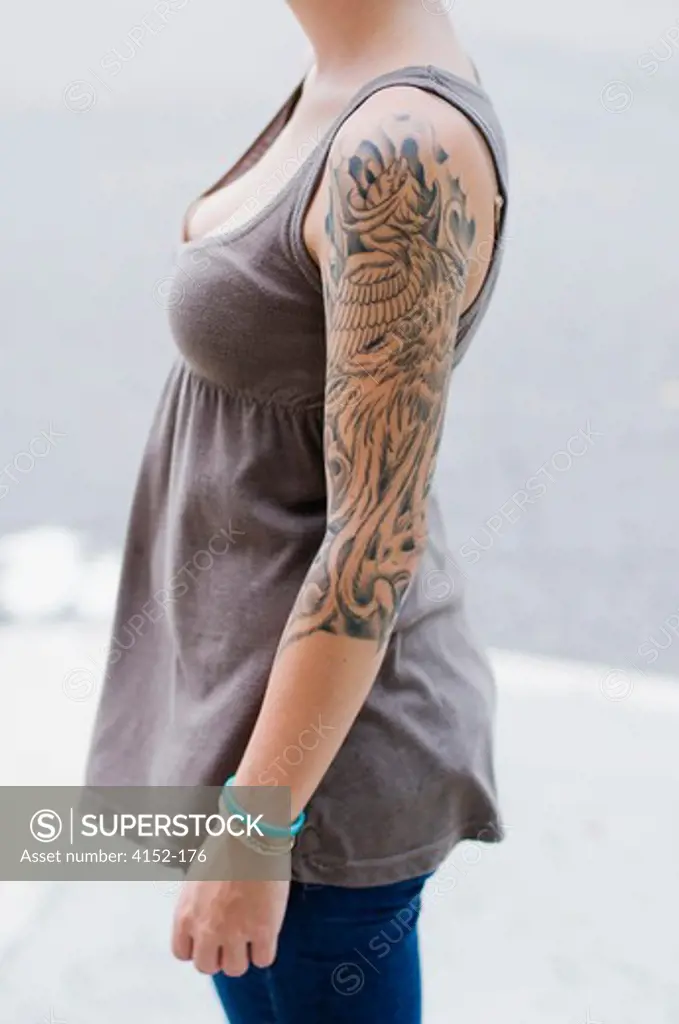 Woman with tattoo design on her arm