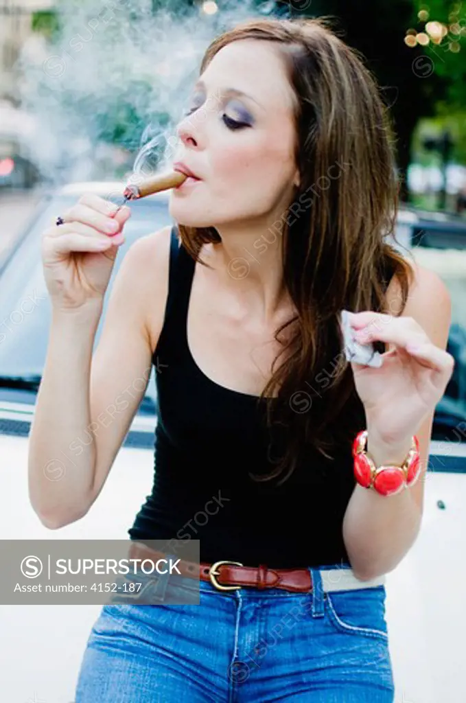 Woman lighting a cigar