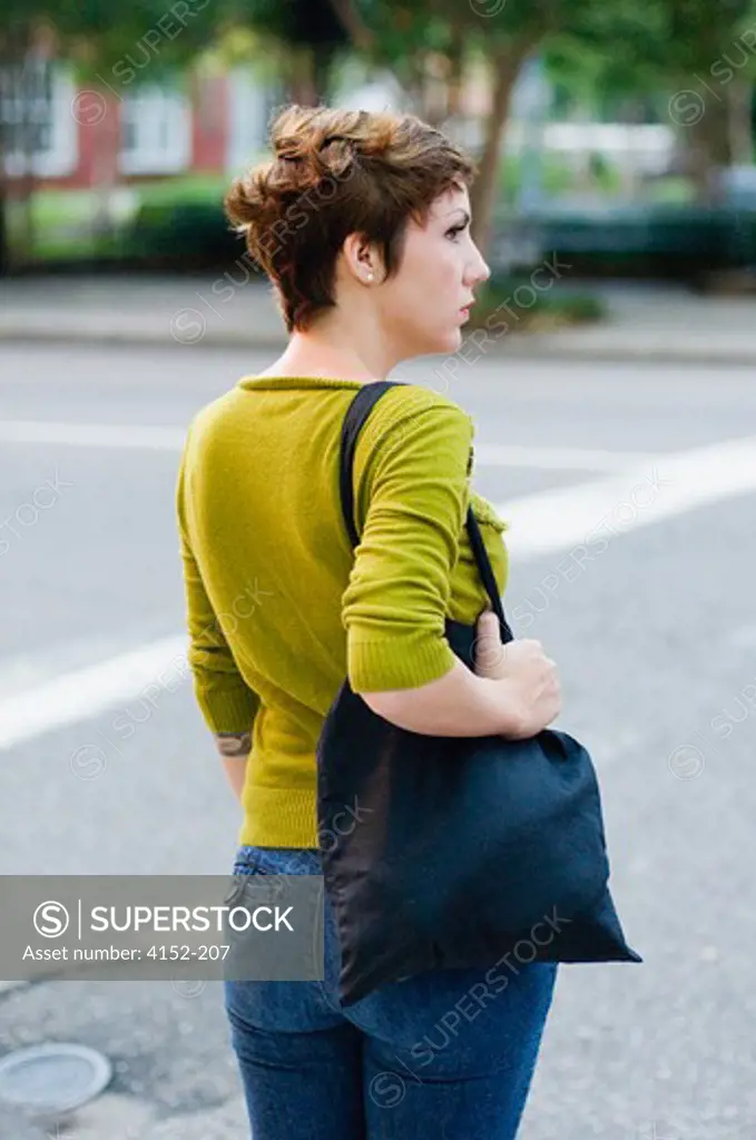 Woman standing at the roadside