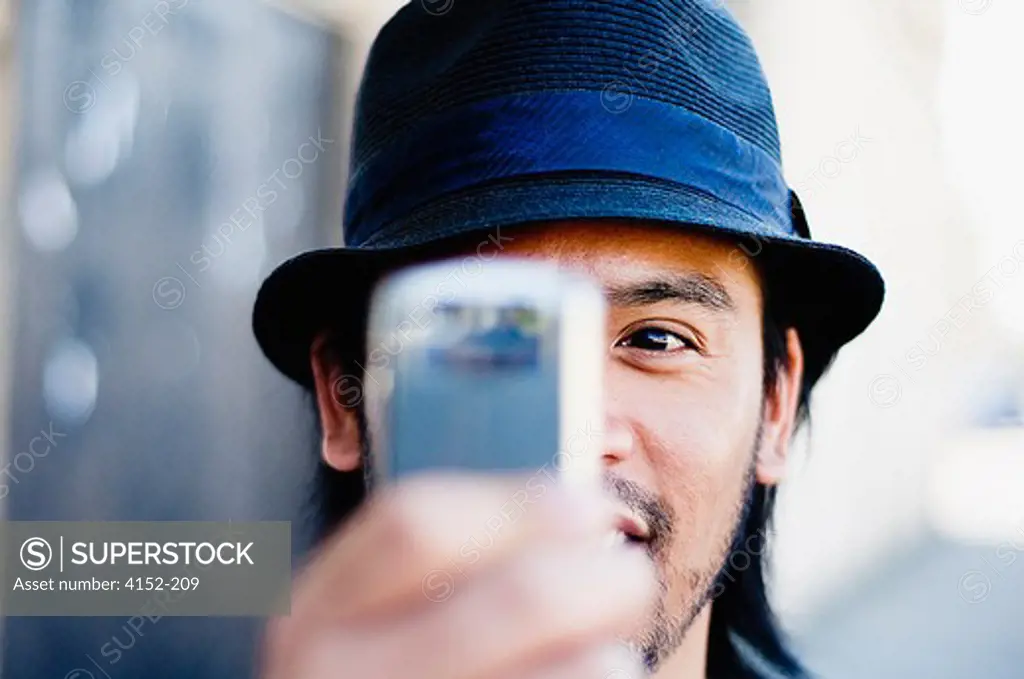 Man taking a picture with a mobile phone
