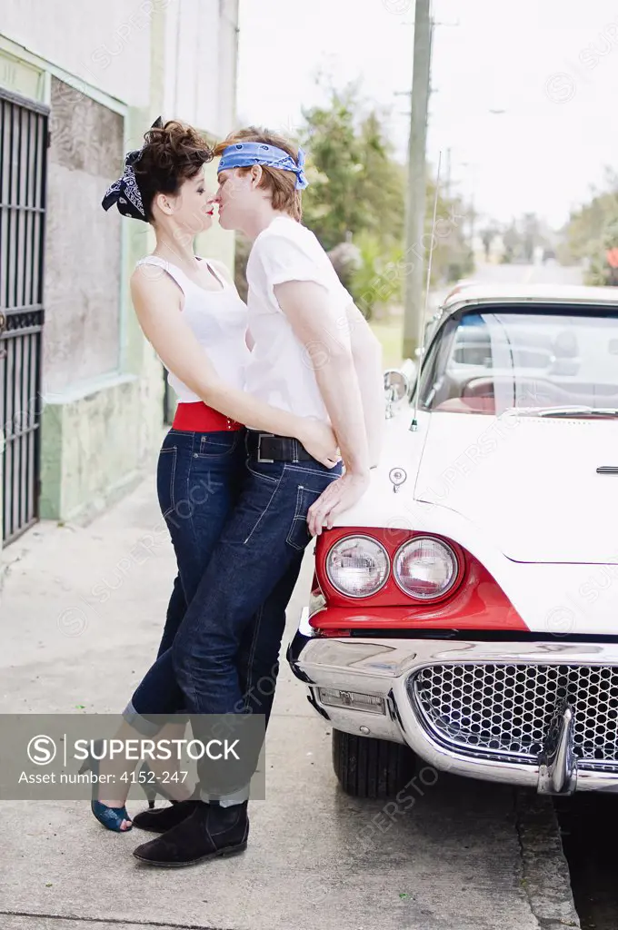 Romantic young couple near a car