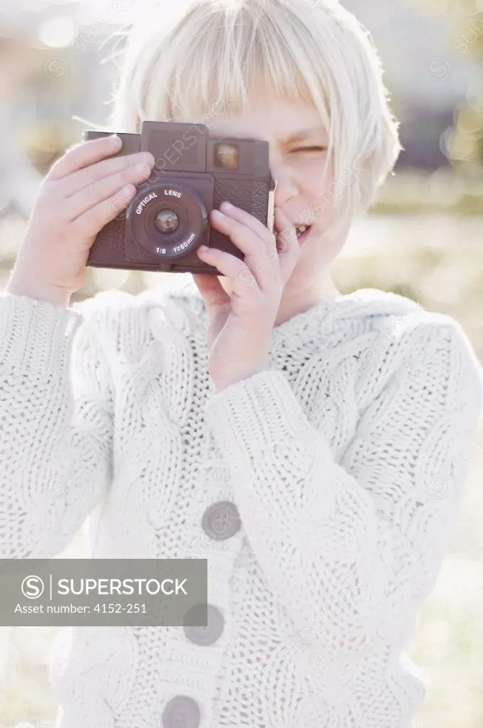 Close-up of a girl holding a camera