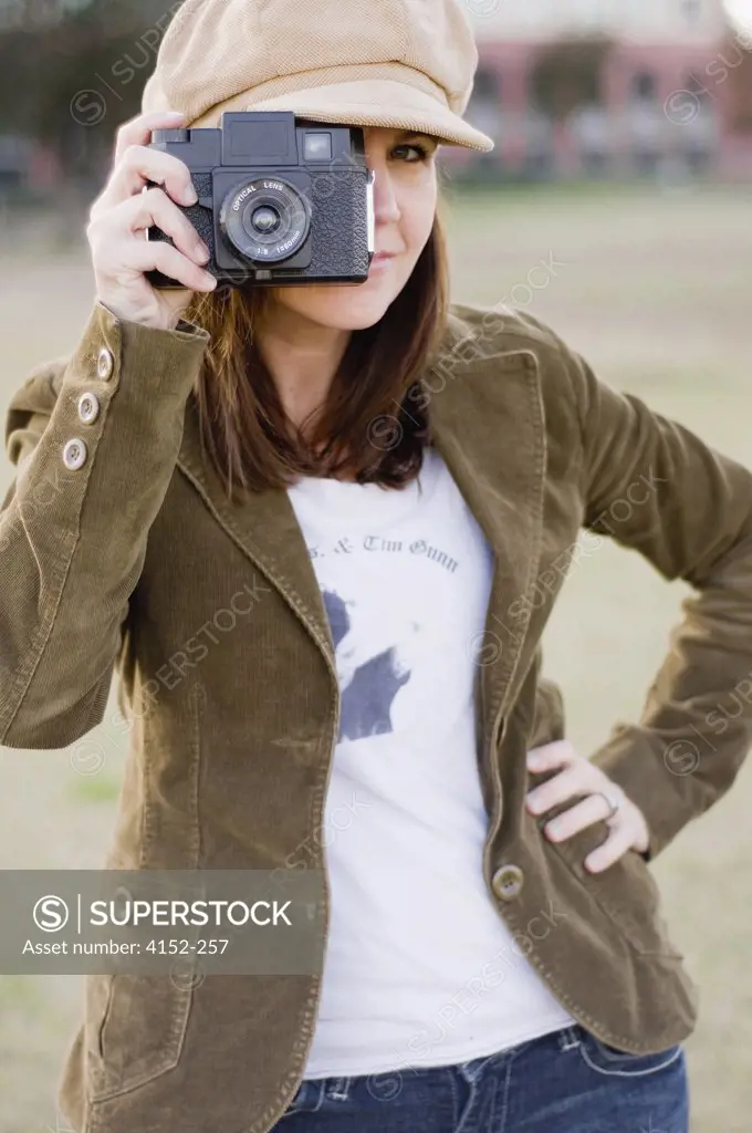 Close-up of a young woman holding a camera