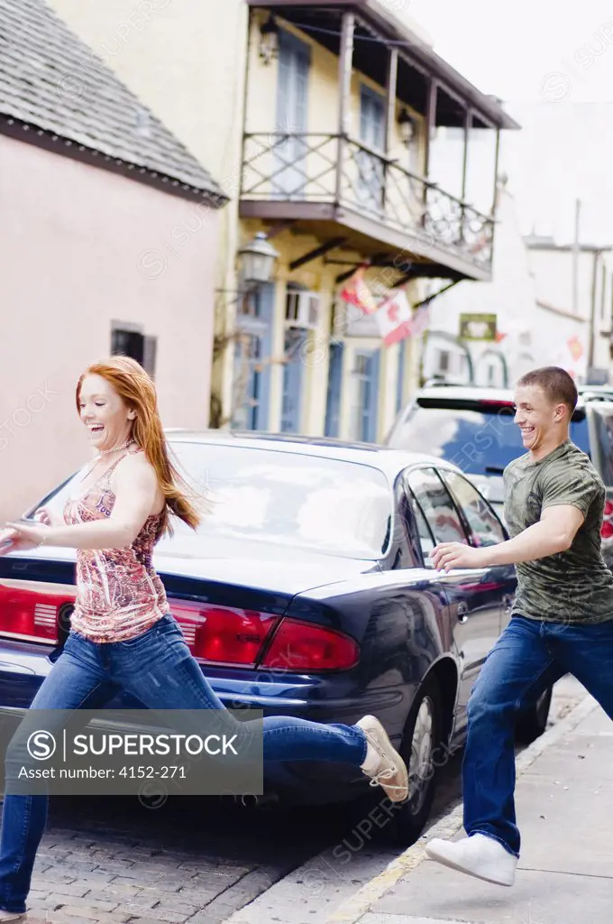 Young couple running on a street