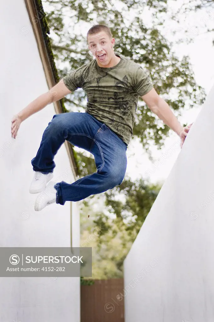 Low angle view of a young man jumping