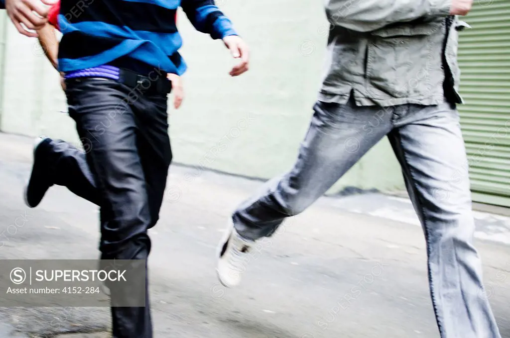 Low section view of two men running