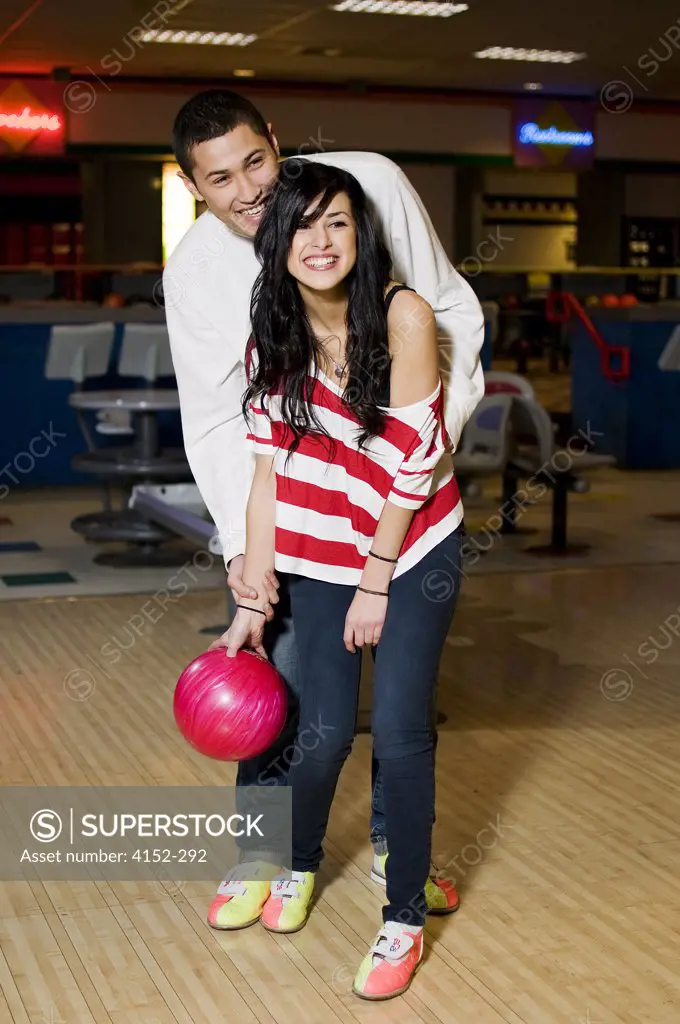 Young couple playing bowling