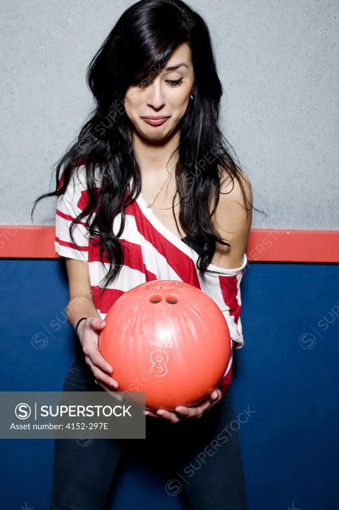 Young woman holding a bowling ball