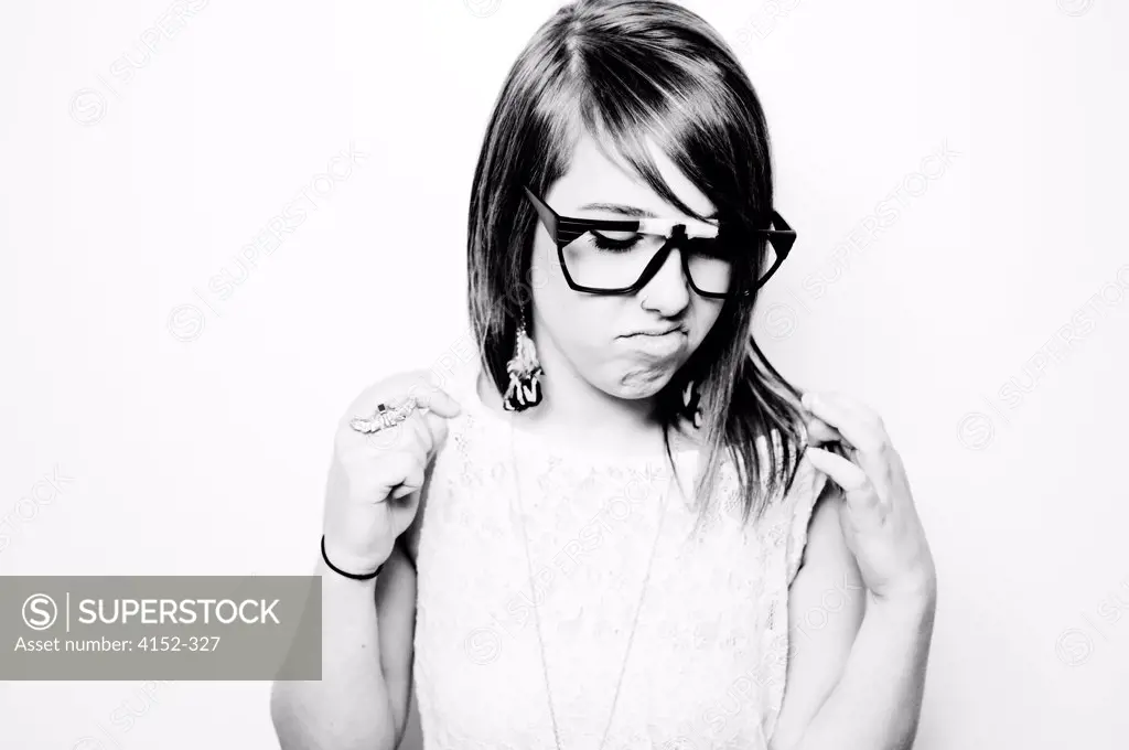 Portrait of young girl in spectacles making a face