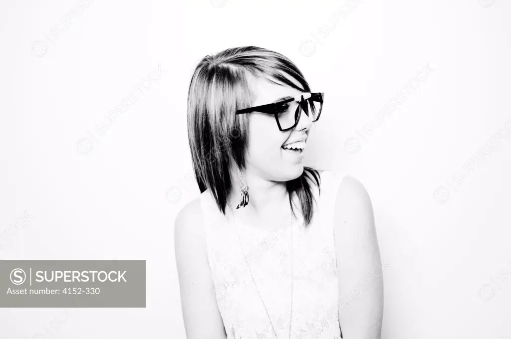Portrait of young girl in spectacles looking away