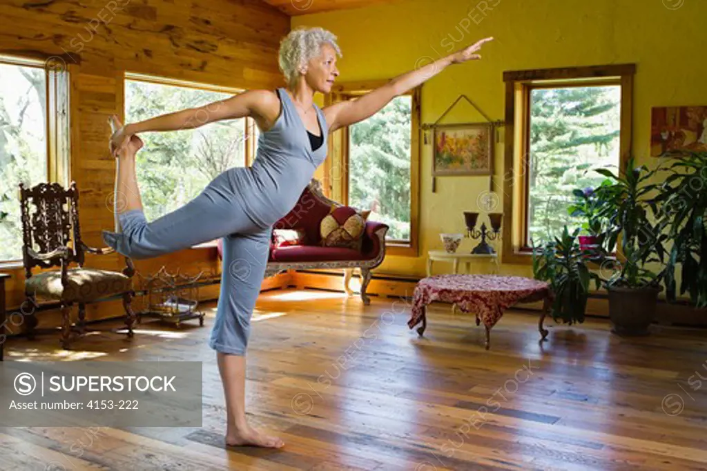 USA, Mature woman exercising at home