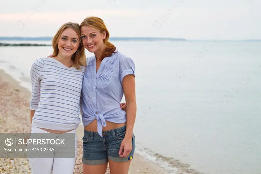 Portrait of two young women standing on beach