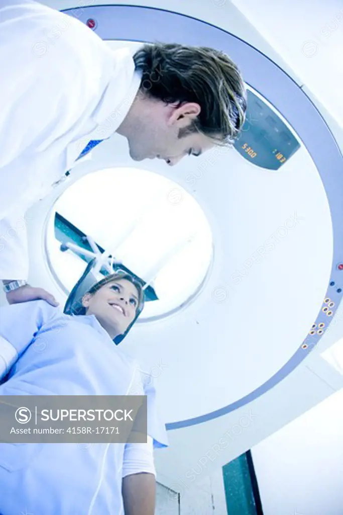 Doctor performing a medical scan to a patient