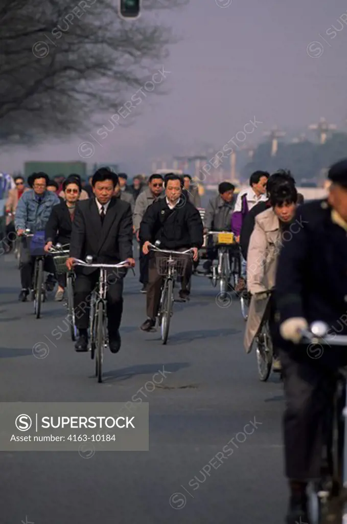 CHINA, BEIJING, STREET SCENE WITH PEOPLE ON BICYCLES