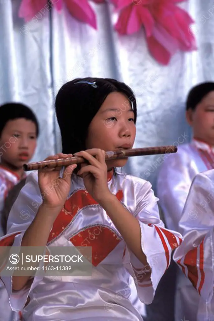 CHINA, SHANTOU, ELEMENTARY SCHOOL, GIRL (STUDENT) PLAYING FLUTE