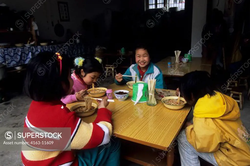 CHINA, GUANGXI PROVINCE, NEAR GUILIN, XING PING VILLAGE SCENE, SCHOOLGIRLS HAVING LUNCH, CHOPSTICKS