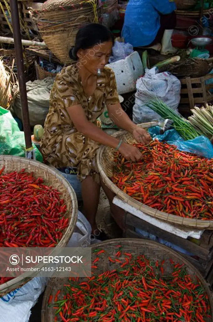 VIETNAM, HUE, MARKET, WOMAN WORKING WITH CHILI PEPPERS