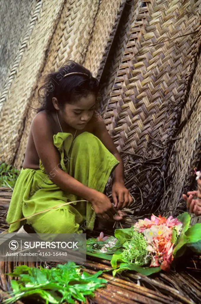 MICRONESIA, CAROLINE ISLS. PULAP ISLAND, NATIVE GIRL MAKING FLOWER LEIS
